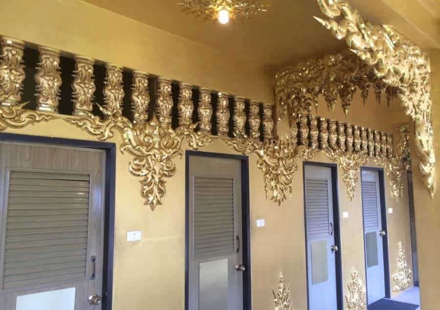 Golden toilet building compartments in white temple chiang rai