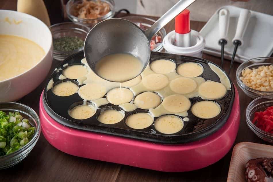 cooking takoyai at home pour the batter into the molds of pan