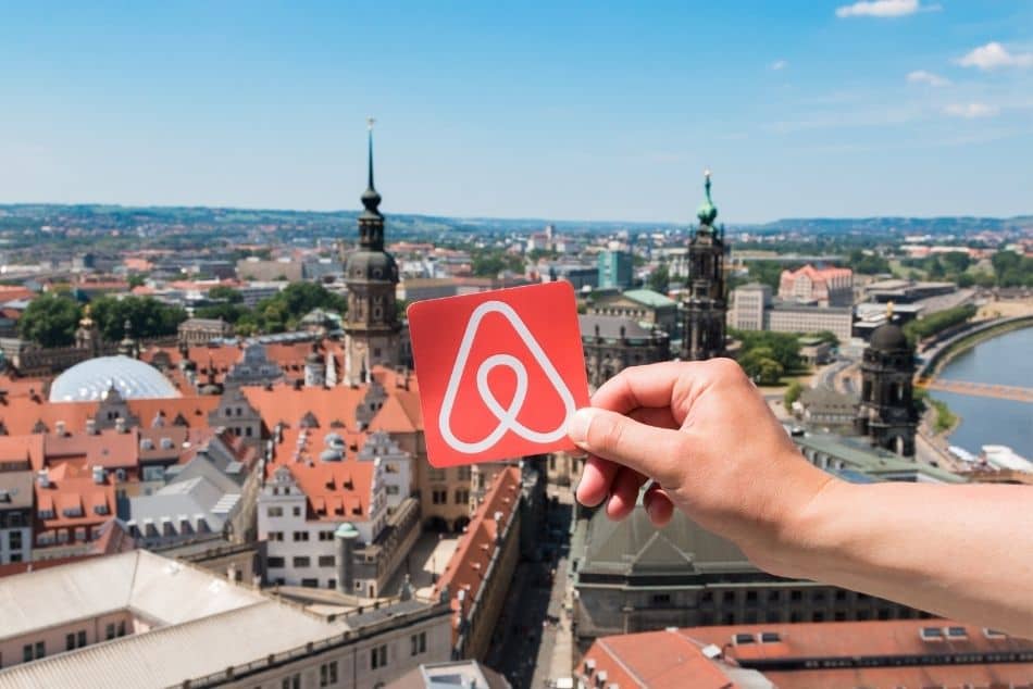man-holding-logo-of-airbnb-dresden-germany-houses