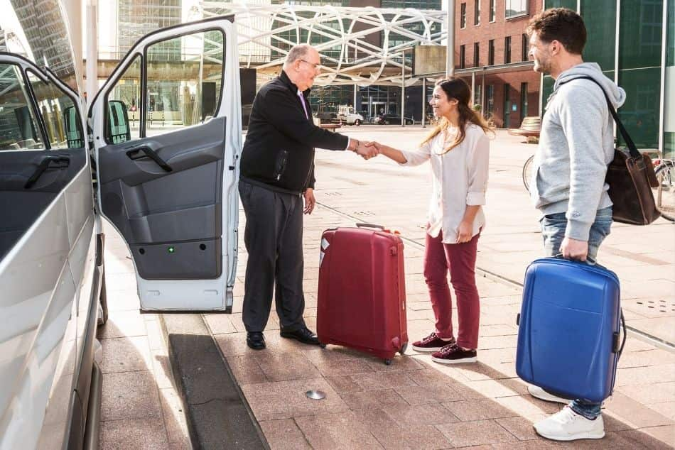 driver-airport-shuttle-minivan-greeting-his-passenger-open-door