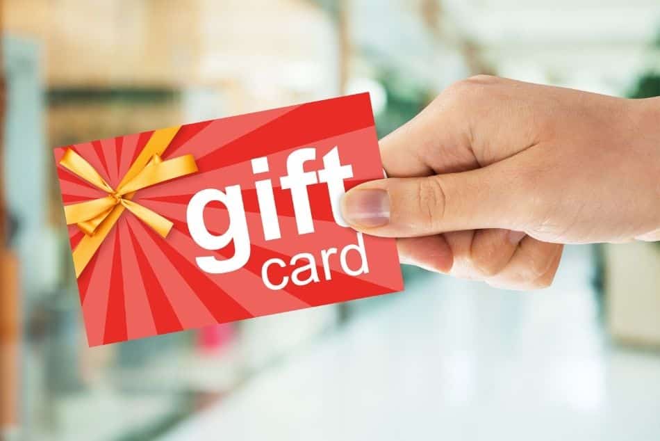 cropped-image-persons-hand-holding-gift-card