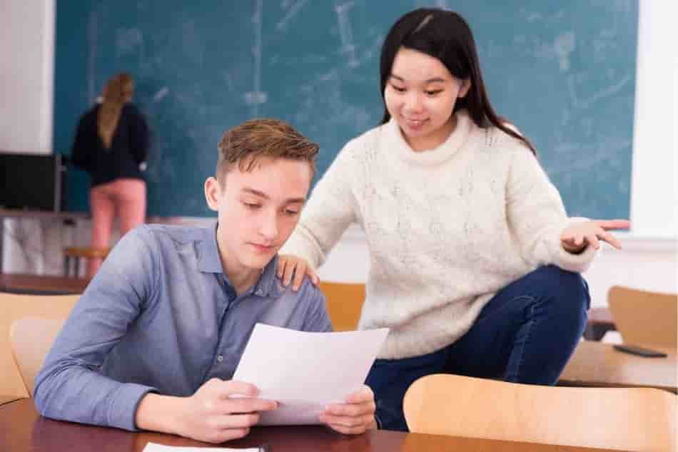 Teen-student-asking-asian-girl-classmate